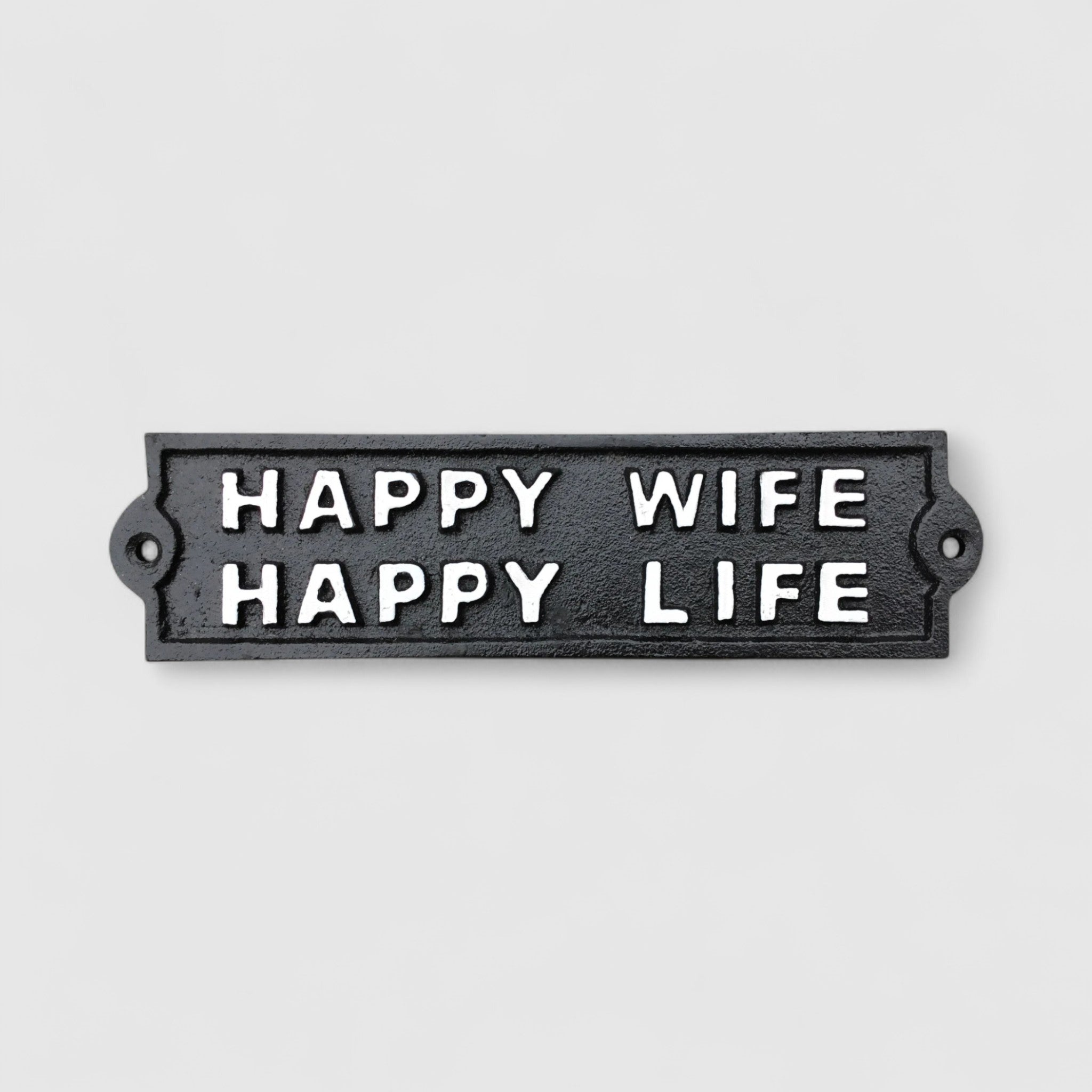 Black cast iron Happy Wife Happy Life sign detail, raised white lettering, humorous plaque