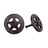 Rustic cast iron star cabinet knob showing front circular face and side profile with weathered dark finish