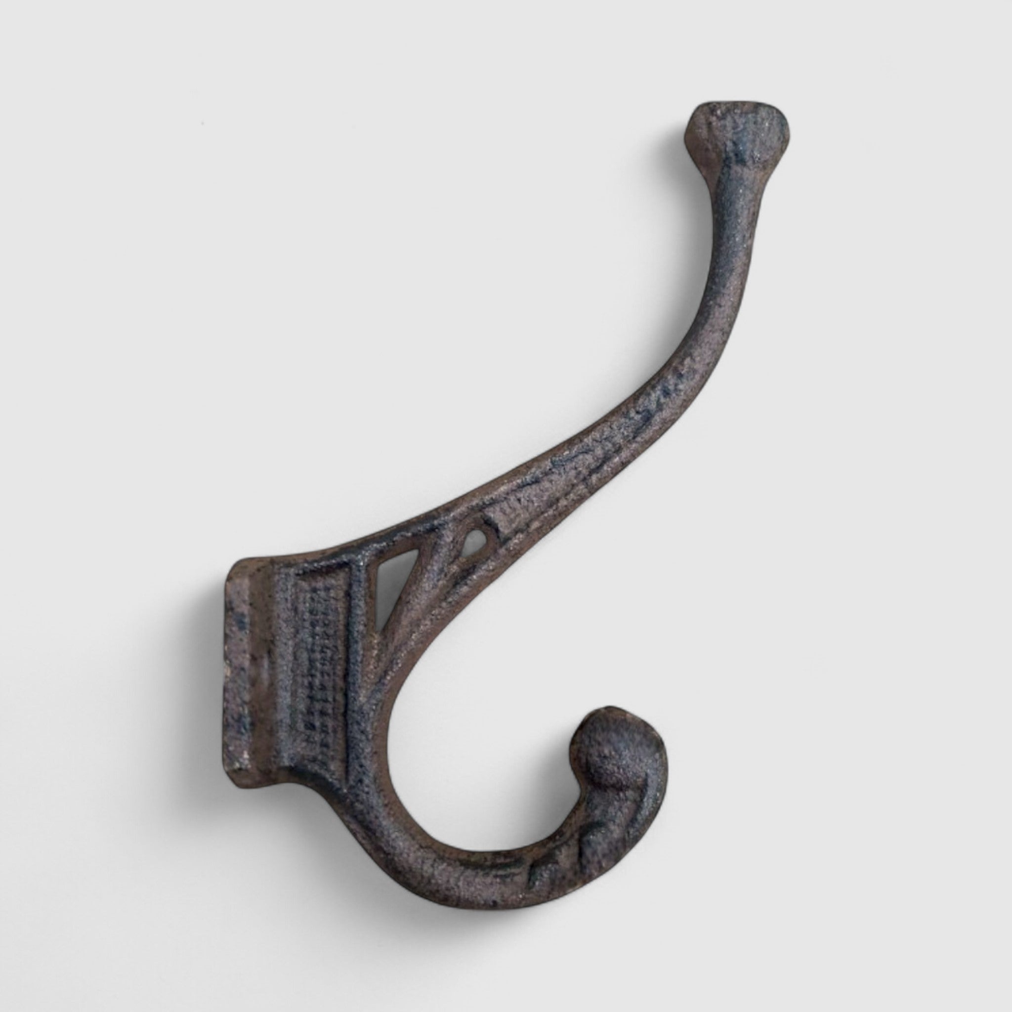 Rustic cast iron hook with dual curved arms, weathered patina, farmhouse wall hanger