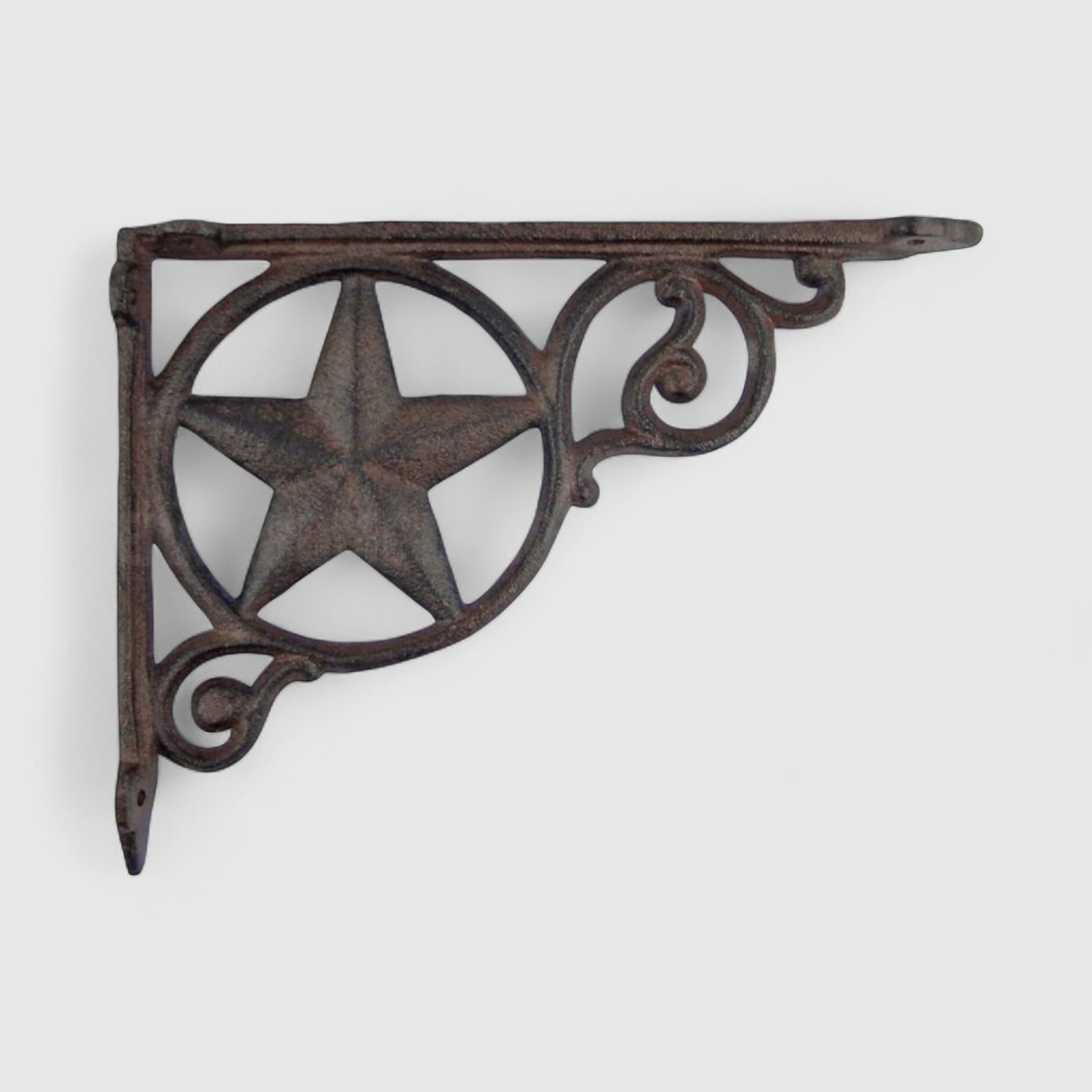 Dark cast iron star bracket with ornate scroll details, vintage western decor accent
