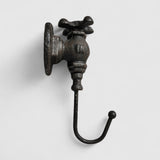 Antique cast iron faucet-form hook, vintage black finish with hardware mounting detail