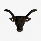 Dark cast iron longhorn bull head wall hook with textured finish and curved horns detail view