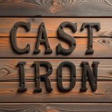 Weathered cast iron CAST IRON letters on rustic wood plank, dark patina finish