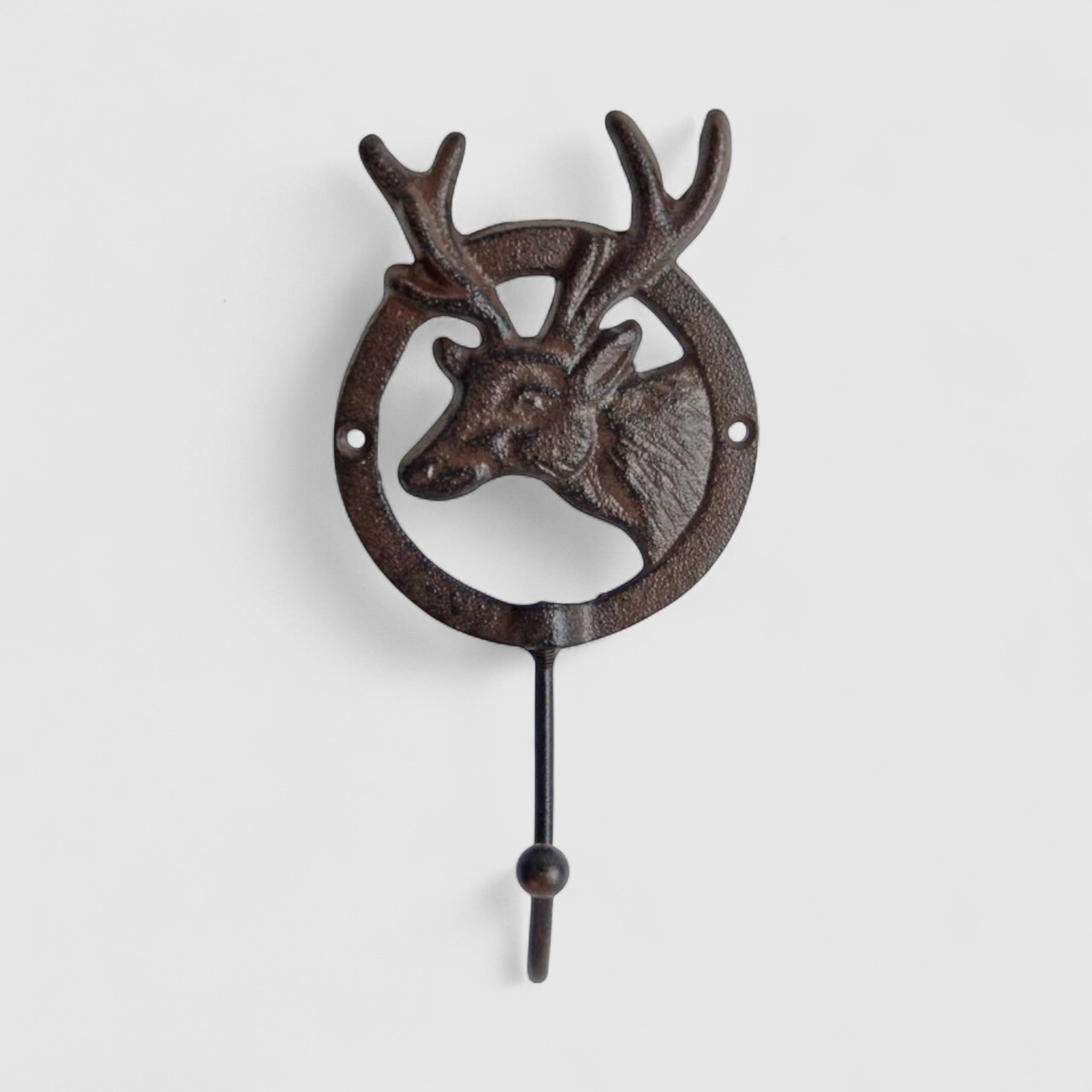 Antique-finish cast iron deer wall hook showing intricate antler detail, dark brown patina