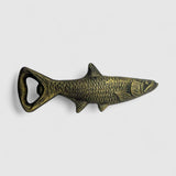 Antique gold cast iron fish bottle opener side profile showing detail and texture