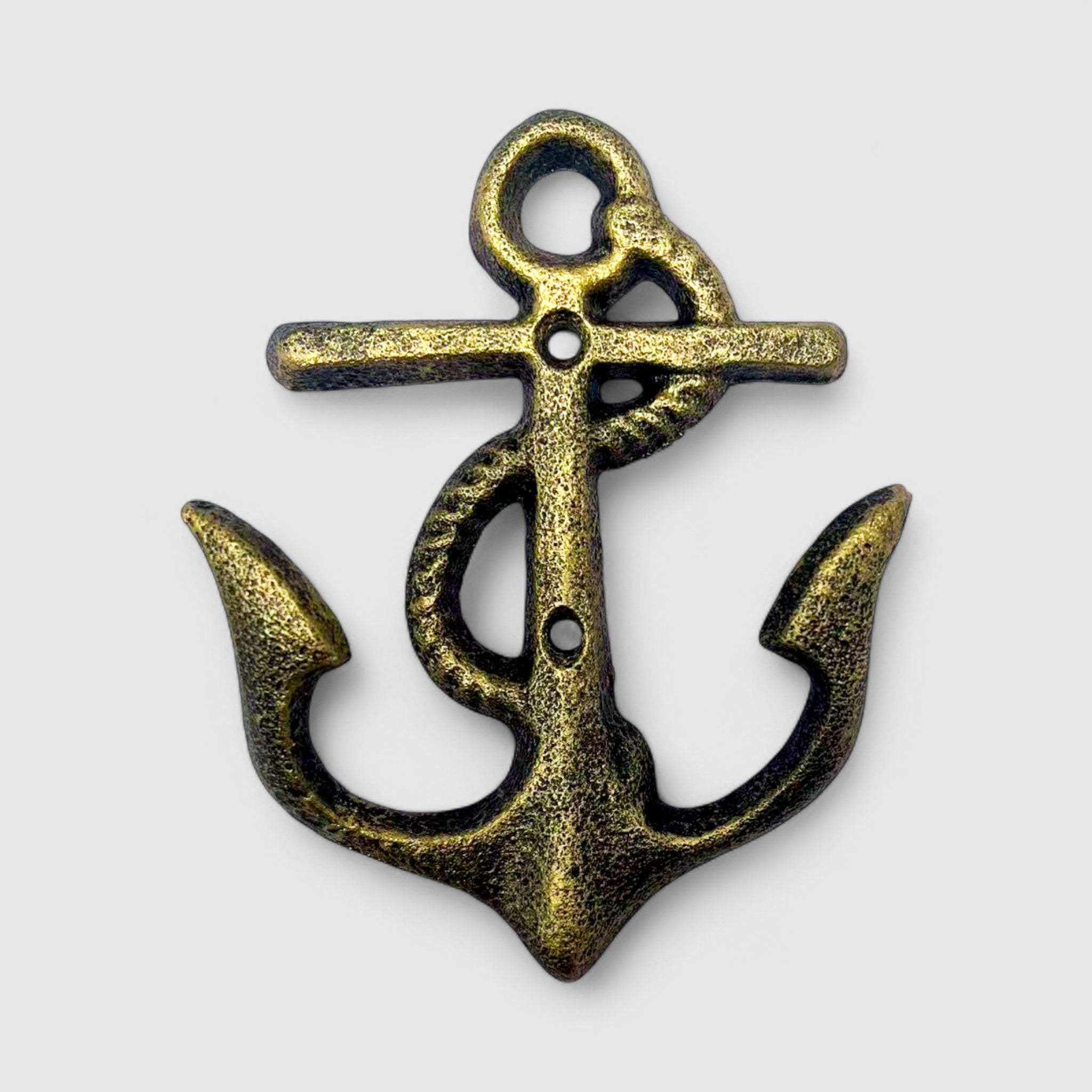 Weathered brass cast iron anchor hook mounted vertically on wall