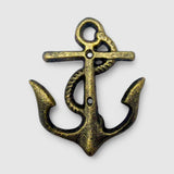 Weathered brass cast iron anchor hook mounted vertically on wall