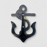 Verdigris patina cast iron anchor hook on turquoise coastal door