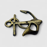 Distressed gold-tone cast iron anchor wall hook, ornate curved design