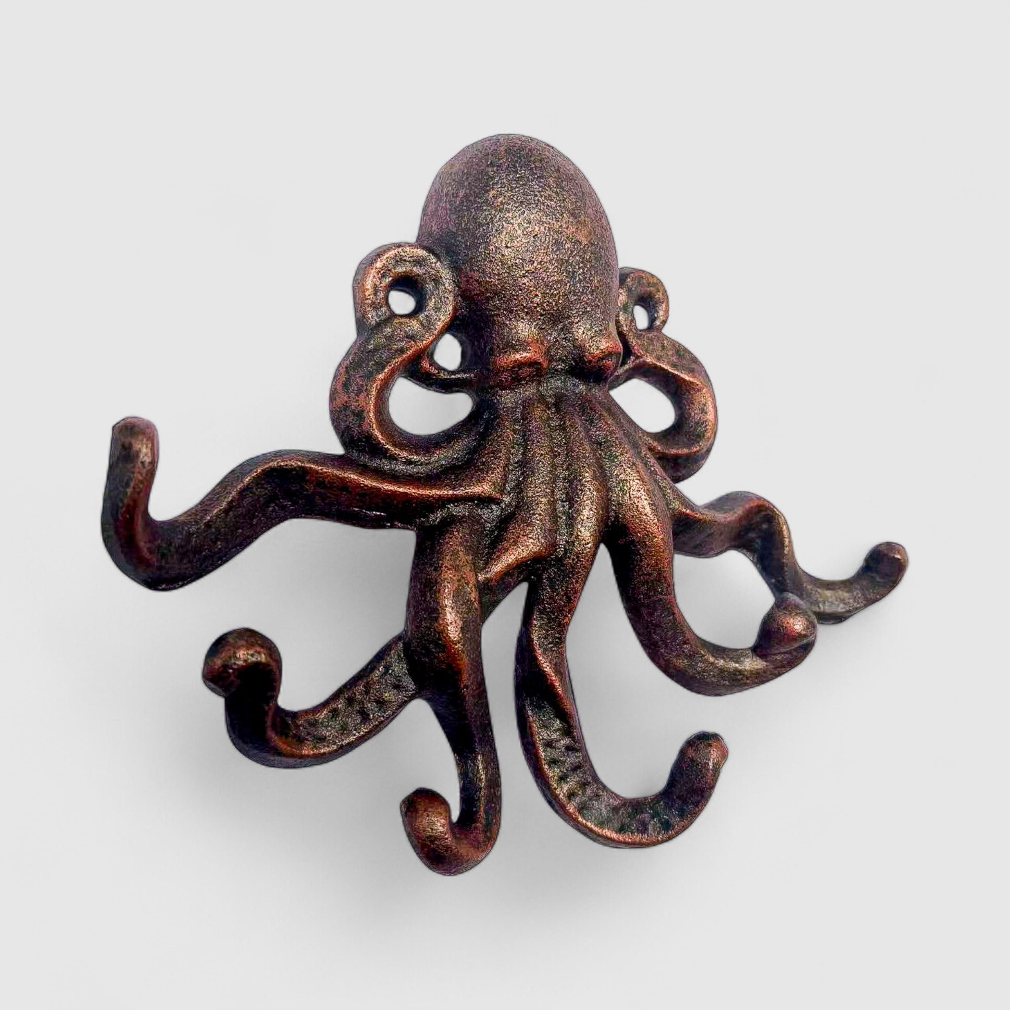 Copper cast iron octopus hook with detailed suction cup details on tentacles, studio shot