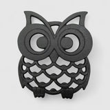 Front-facing cast iron owl trivet with concentric eye rings and textured feather body design
