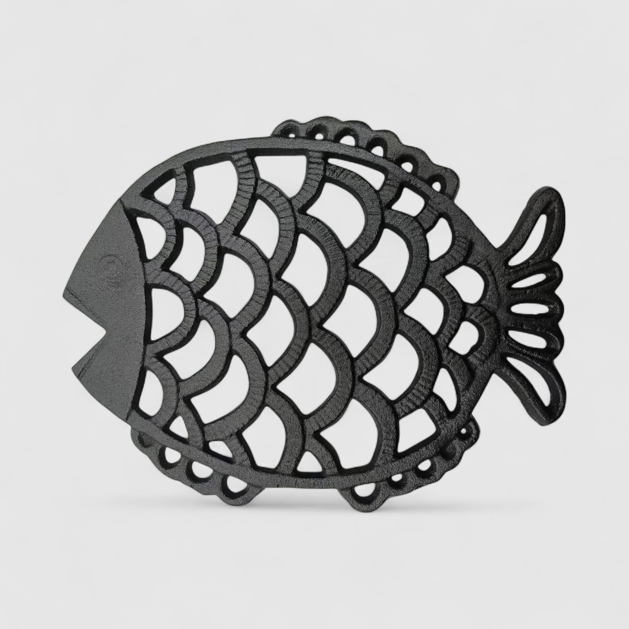 Front-view textured dark iron fish-shaped trivet with detailed scale pattern cutouts