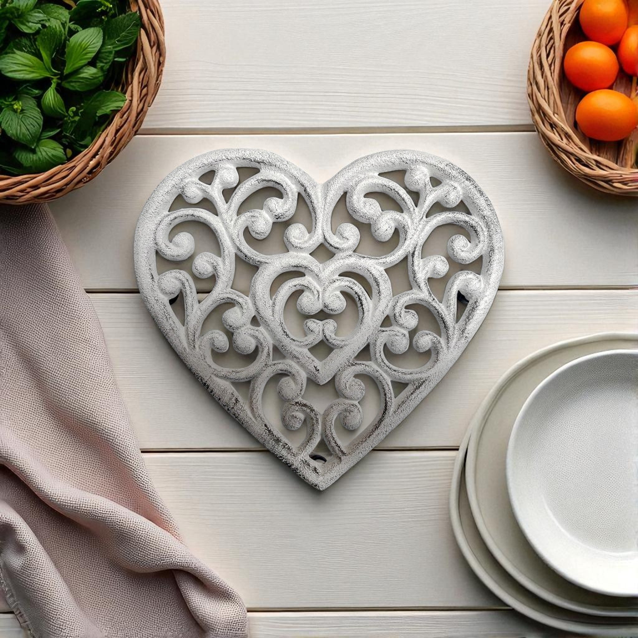 Cast iron heart-shaped trivet with filigree pattern, white finish tabletop decoration