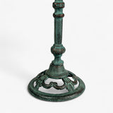 Cast iron pedestal bird bath full view with verdigris patina, decorative stem, and ornamental tripod base
