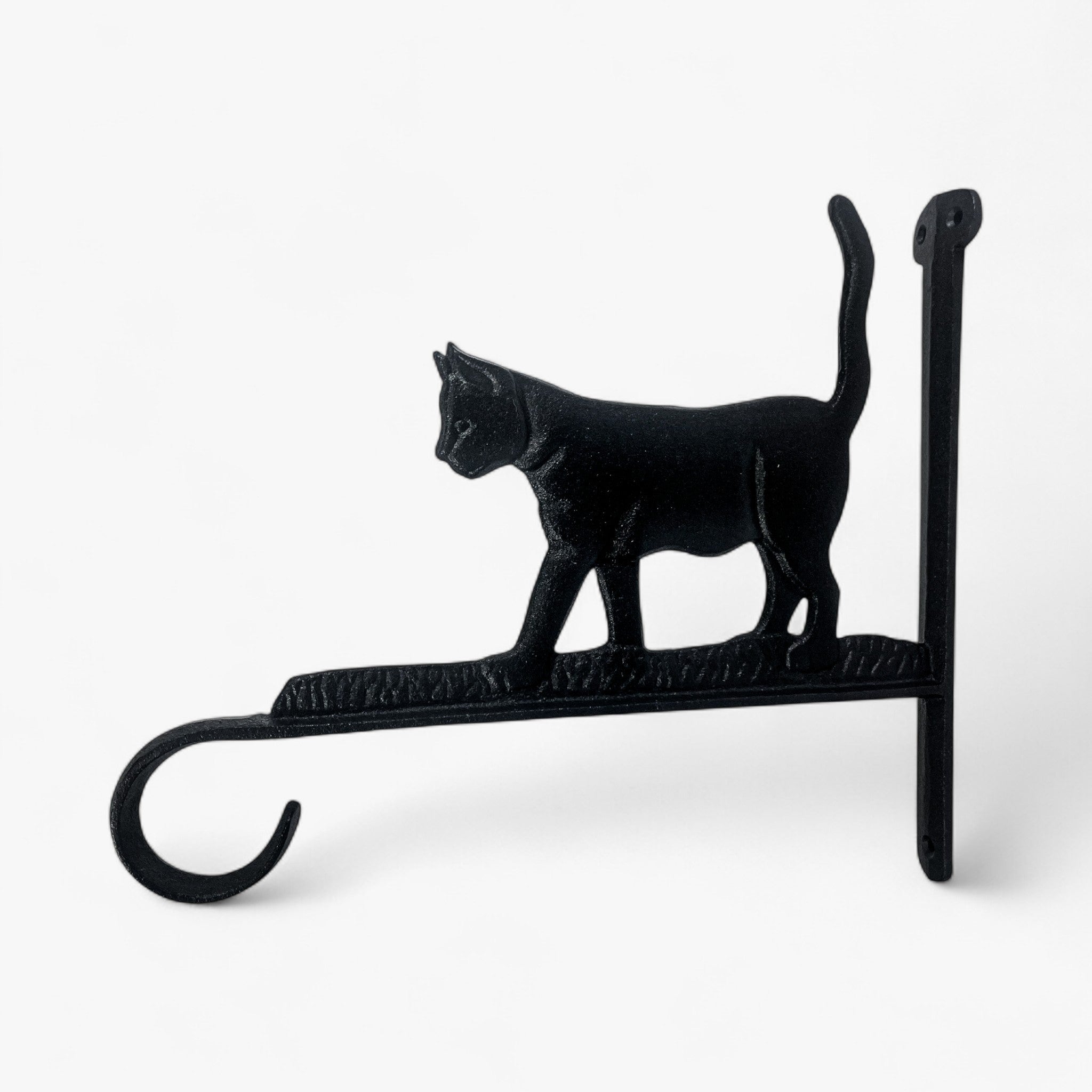 Black cast iron cat wall bracket viewed from side showing tail curvature and textured base