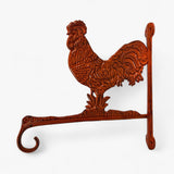 Close-up of rust-colored cast iron rooster head with detailed feather etching