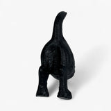 Cast iron dog statue with raised tail, textured black finish, standing view
