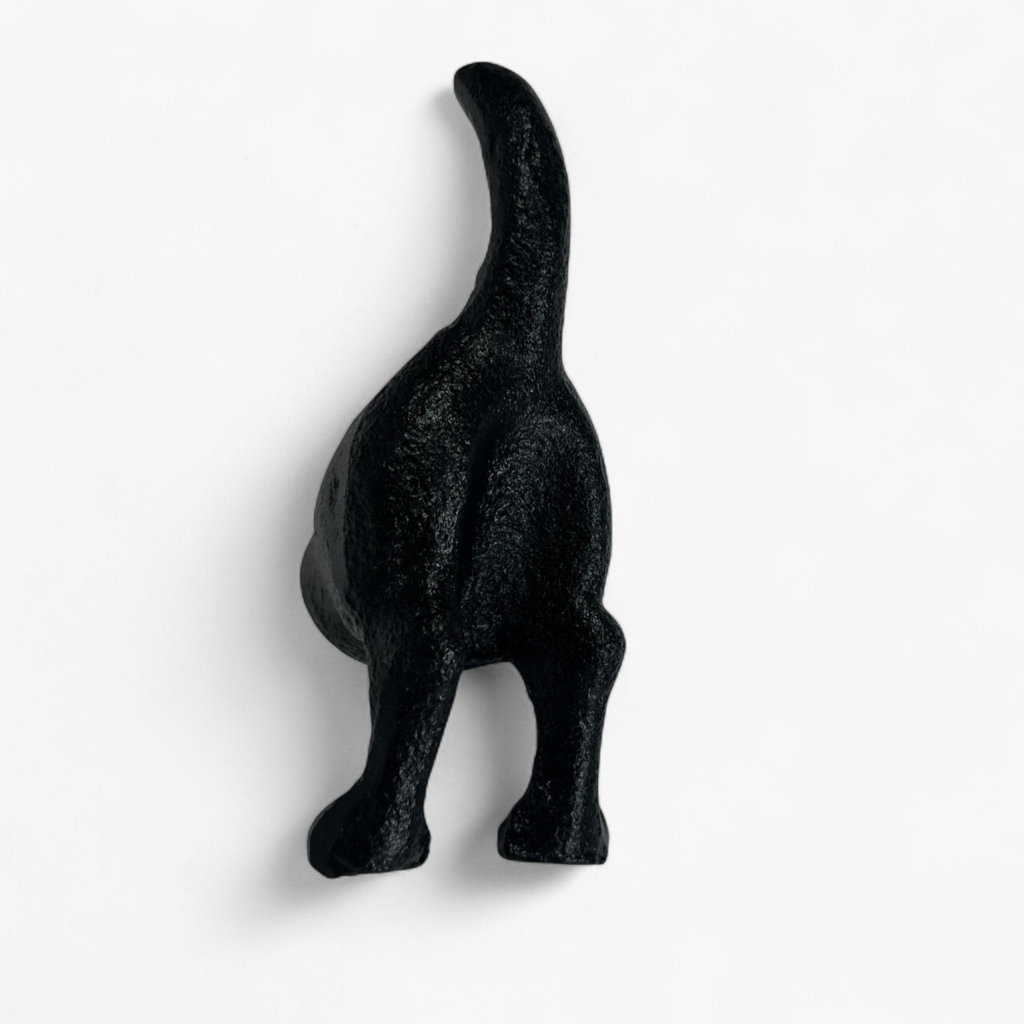 Black cast iron dog hook side profile, curved tail design, rustic metal