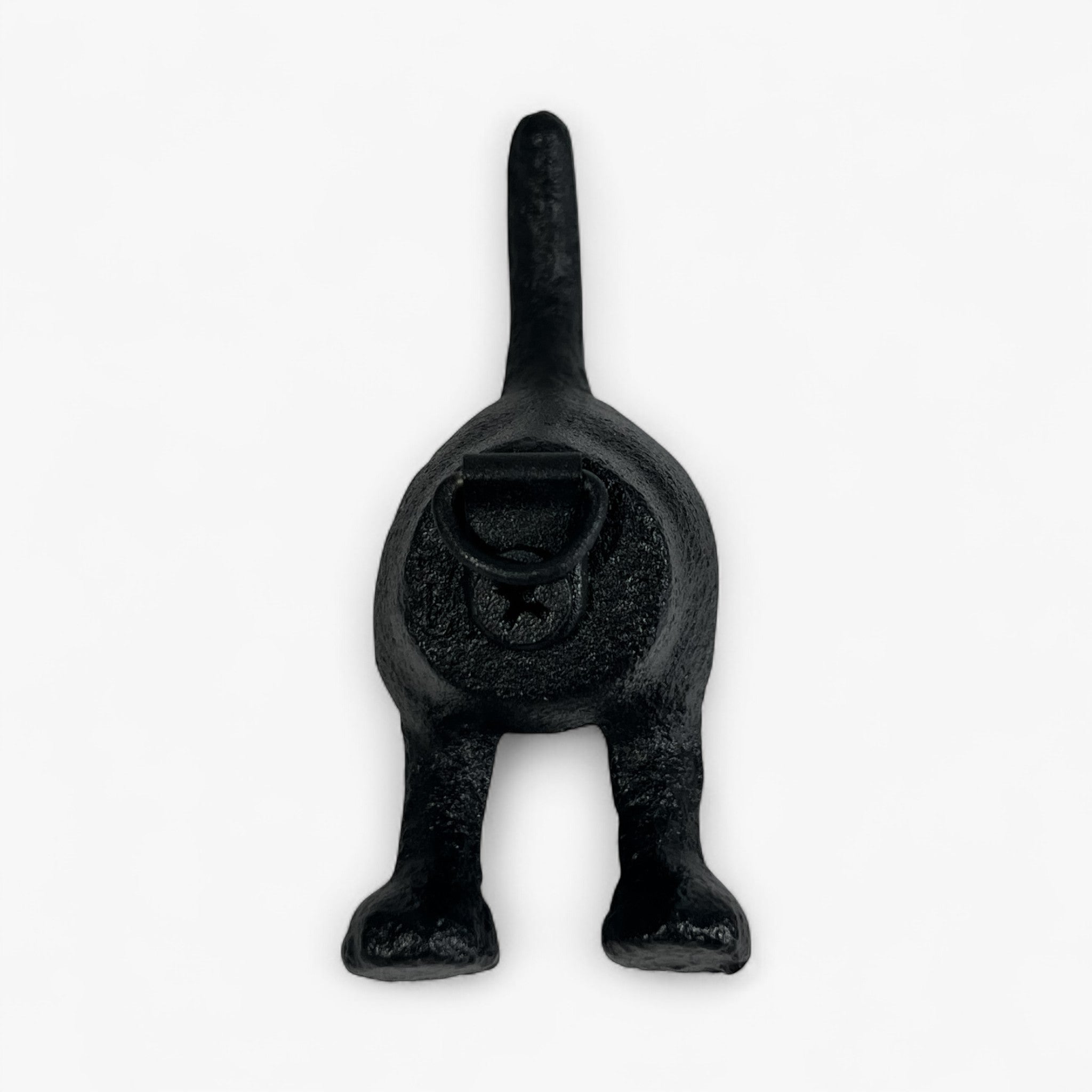 Black cast iron dog tail wall hook with rustic textured finish, wall-mounted home decor accent