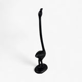 Black cast iron flamingo toilet paper holder with curved neck and round base