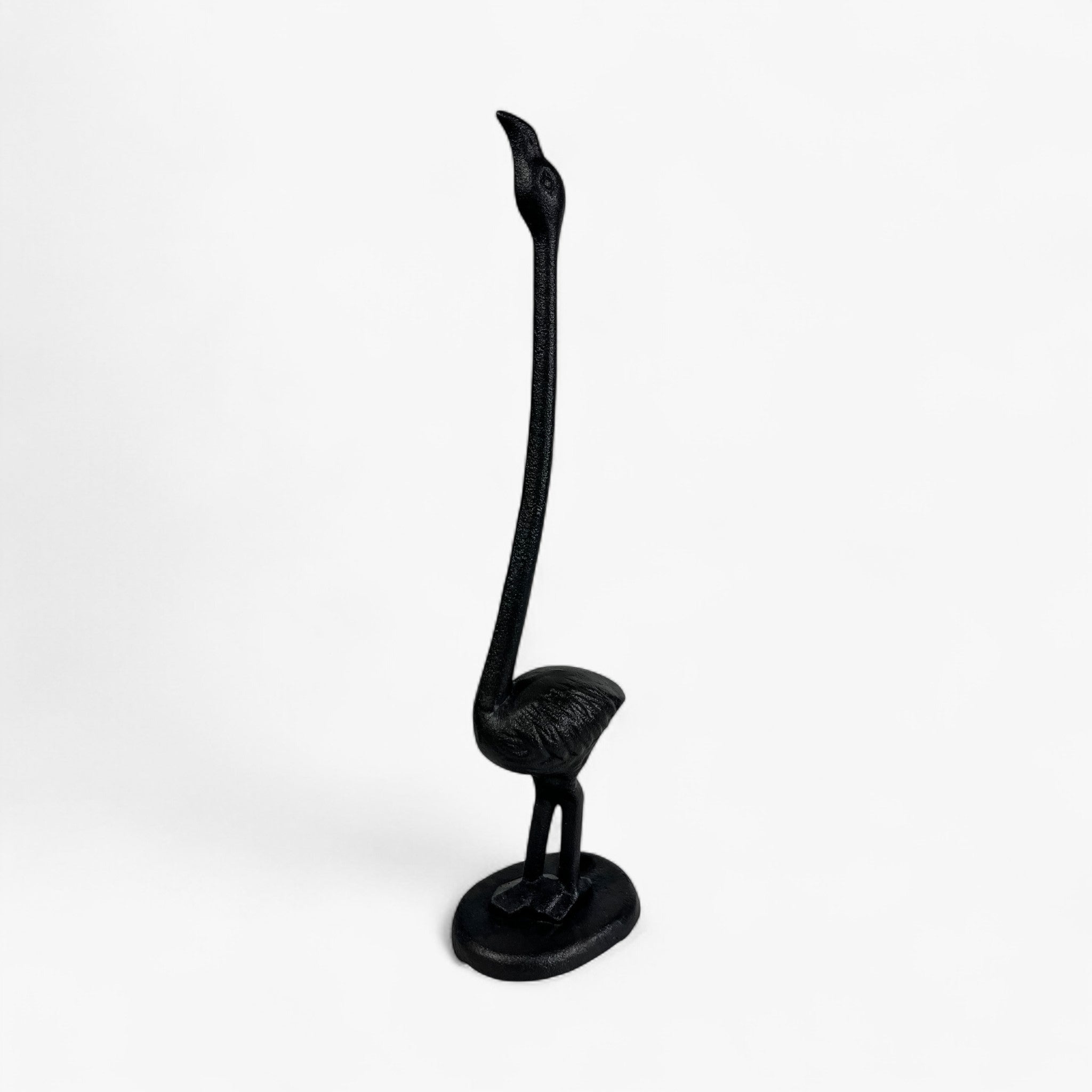 Cast iron flamingo paper holder side angle showcasing curved neck and weighted base
