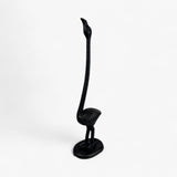 Cast iron flamingo paper holder side angle showcasing curved neck and weighted base