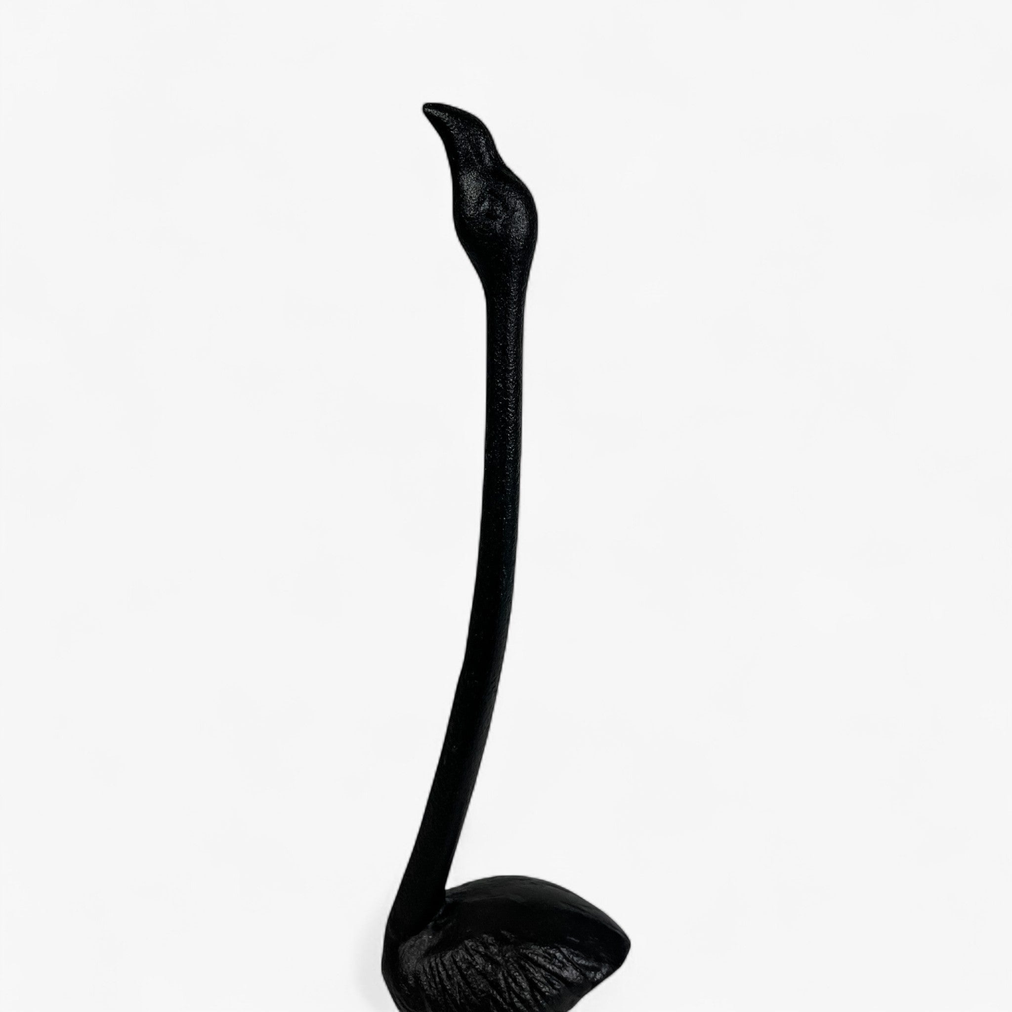 Close-up black cast iron flamingo toilet paper holder showing textured feather finish