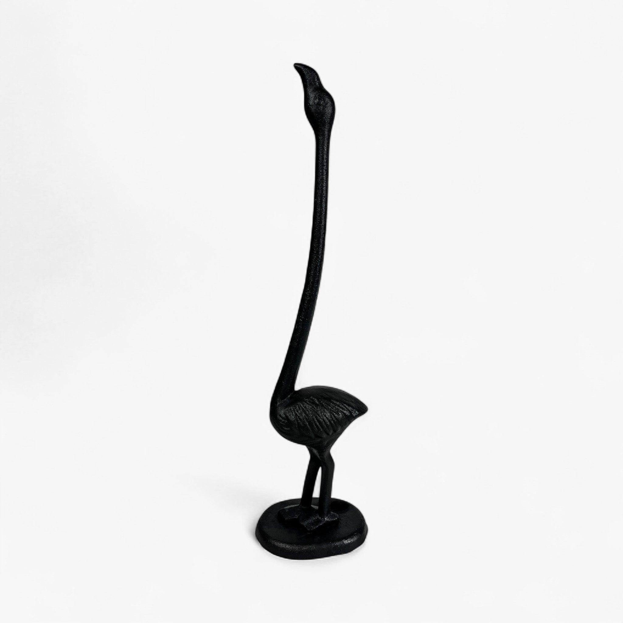 Black cast iron flamingo paper holder with extended curved neck and pedestal base