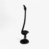 Black cast iron flamingo paper holder with extended curved neck and pedestal base
