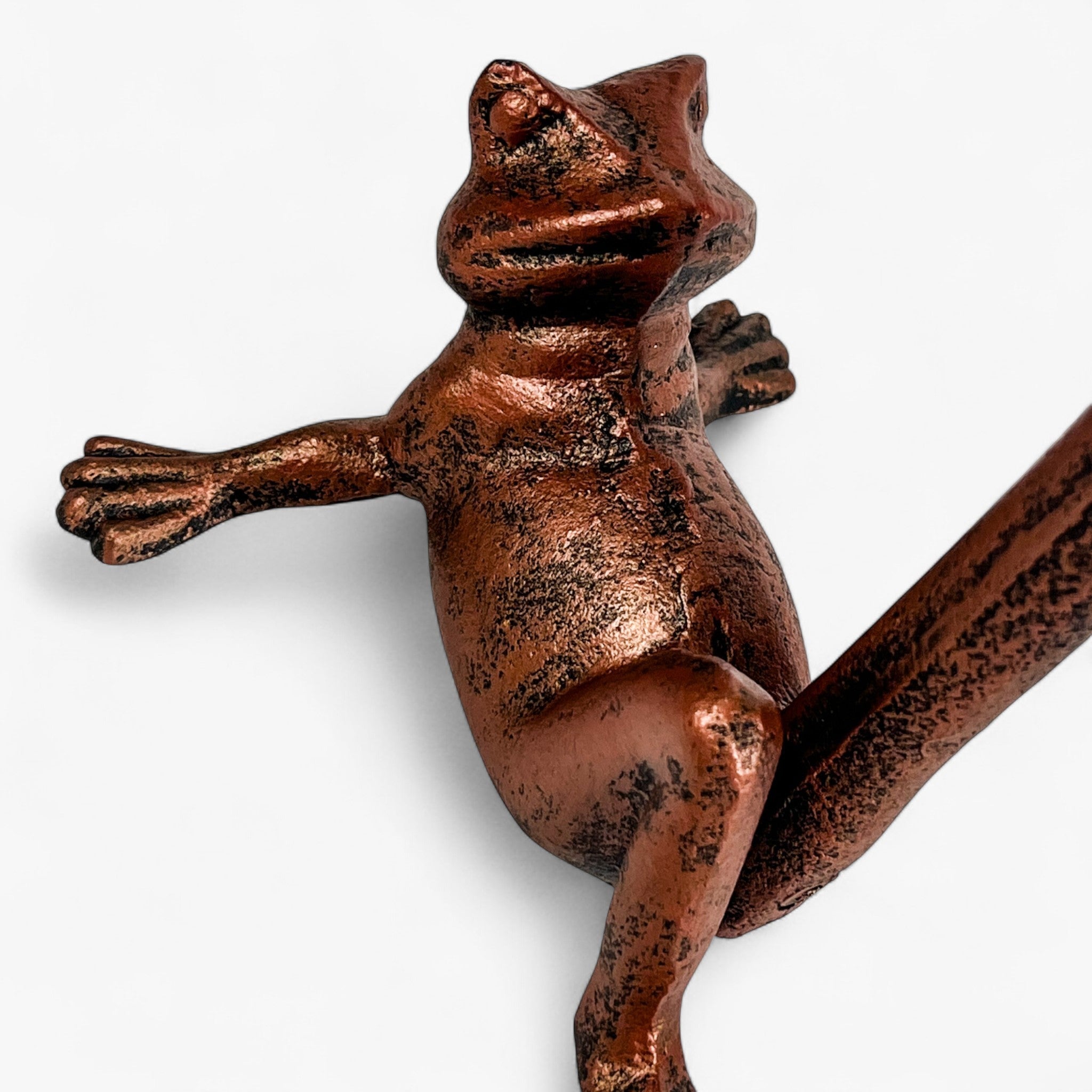 Frog-shaped cast iron towel holder with textured copper patina closeup