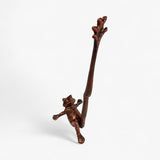 Cast iron frog paper towel holder with weathered copper finish, standing on hind legs front view