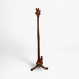 Weathered copper cast iron frog towel holder with tall curved stem and branched top vertical view