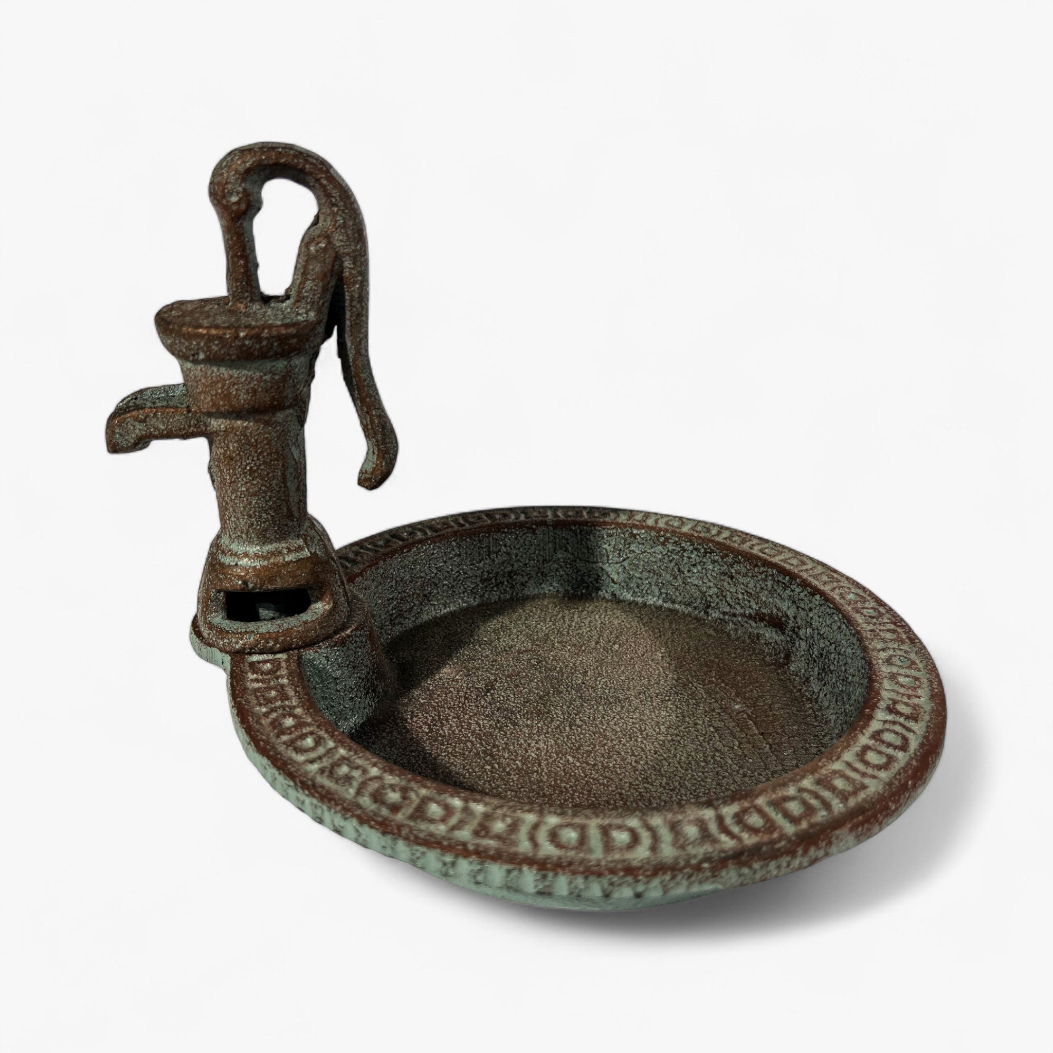 Cast iron water pump bird bath basin with decorative border detail and spout, angled view