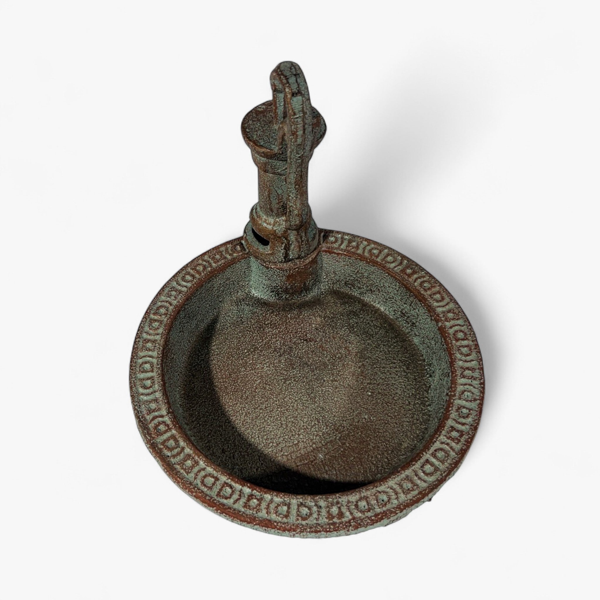 Vintage cast iron garden pump bird bath with rust-brown weathered patina, centered composition