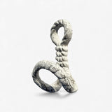Close-up of white textured cast iron rope hook with decorative twist detail