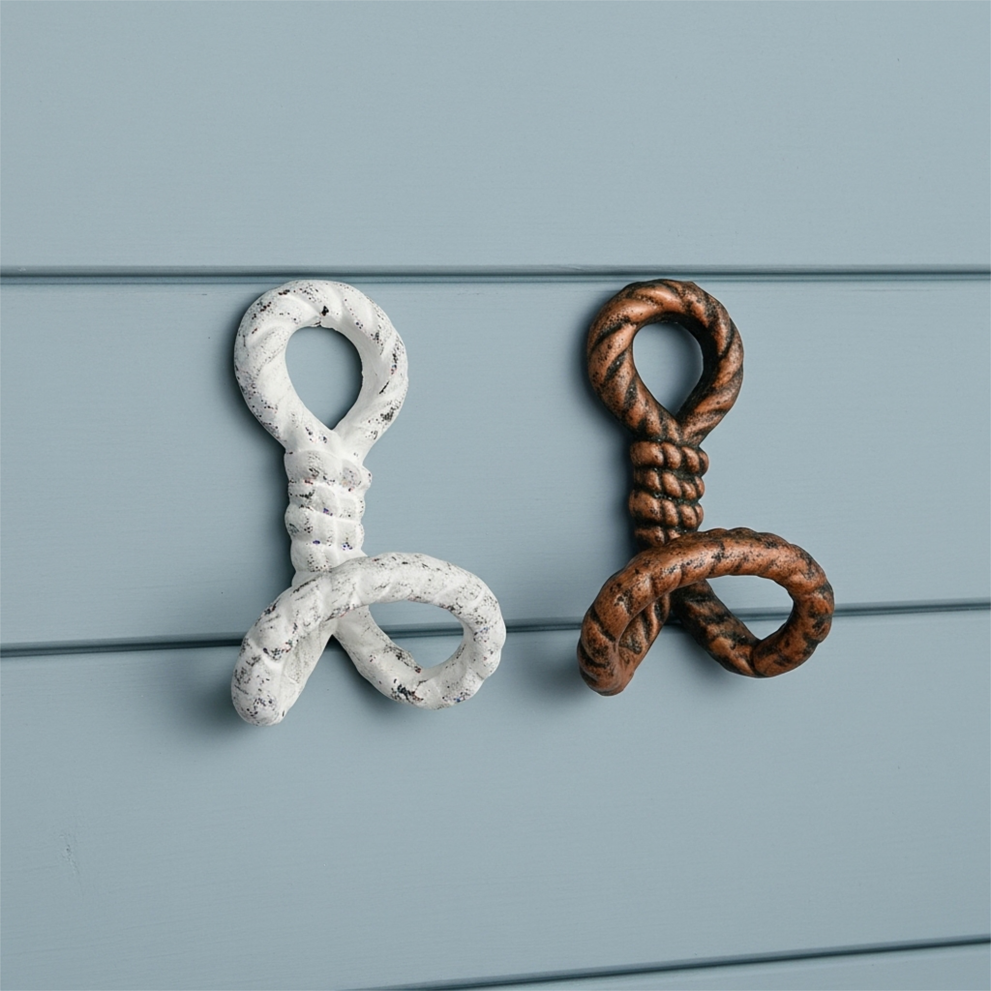 White and copper cast iron rope wall hooks set of 2 displayed on blue shiplap wall