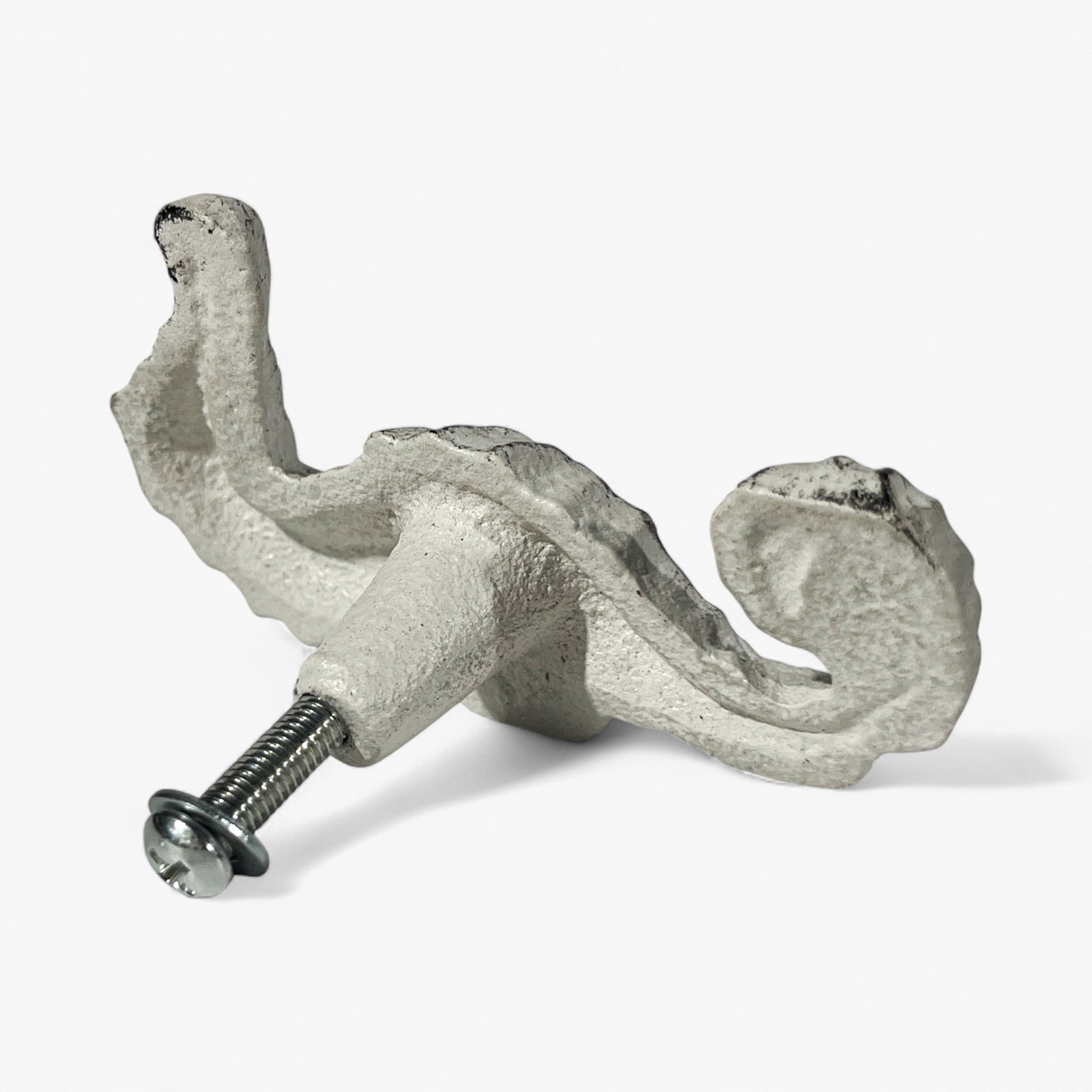 Cast iron seahorse cabinet hardware attachment showing curved pull detail and hardware mounting