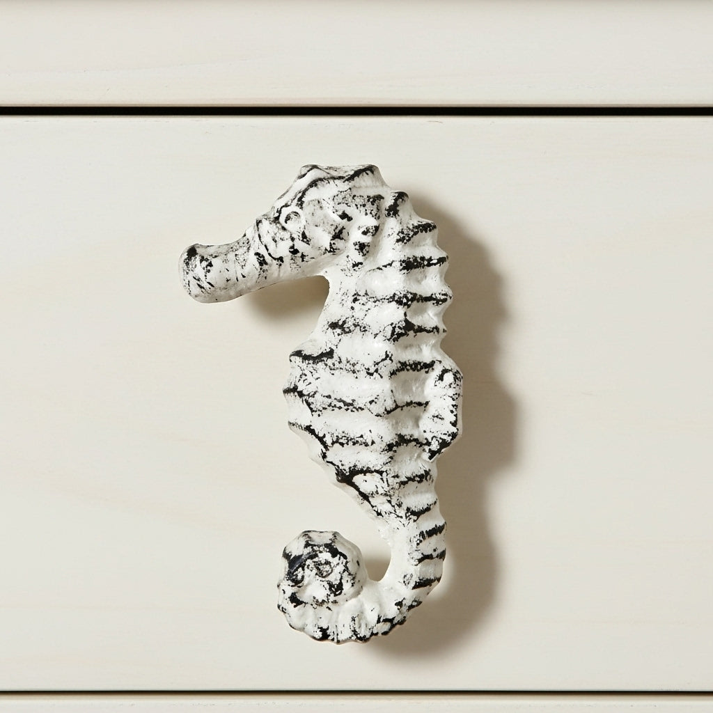 Distressed white seahorse drawer pull with textured cast iron finish, coastal cabinet knob front view
