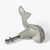 Decorative cast iron whale cabinet knob in use on white painted dresser drawer