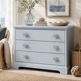 Coastal blue dresser with distressed white ship wheel knobs and seaside decor