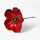 Close-up of red poppy cast iron flower head with black and yellow center detail