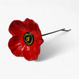 Three cast iron flower stakes: yellow sunflower, yellow daffodil, and red poppy with stems