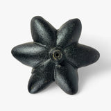 Black cast iron flower bud garden stake with textured finish and brass center