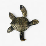 Gold distressed cast iron sea turtle hook featuring shell texture and dual flippers