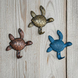 Set of 3 coastal cast iron sea turtle wall hooks in bronze, gold, and turquoise with shell detail