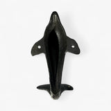 Dark cast iron dolphin tail hook, back view showing hollow body and mounting holes