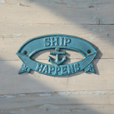 Turquoise cast iron Ship Happens nautical sign with anchor and banner detail wall decor