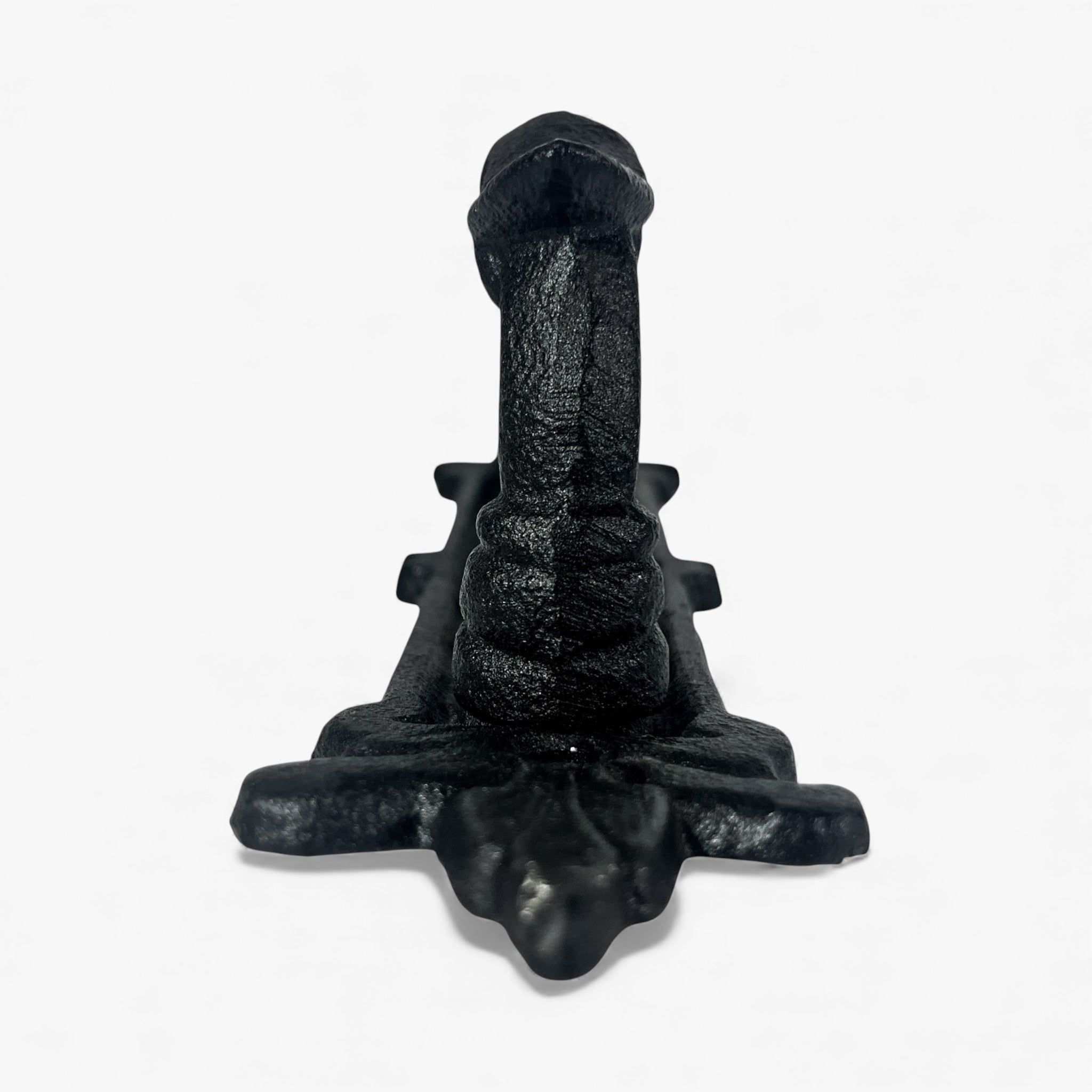 Black cast iron door pull base showing textured metal patina and ornamental design