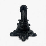 Black cast iron door pull base showing textured metal patina and ornamental design