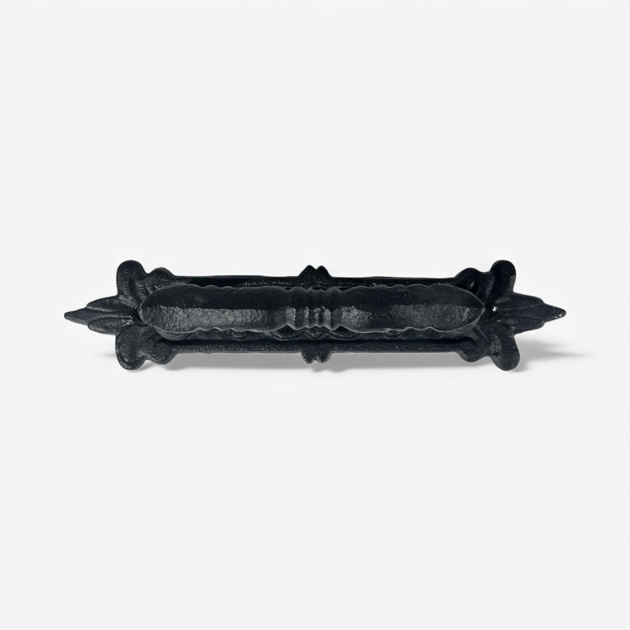 Cast iron rustic pull hardware showing decorative wraparound escutcheon plate detail